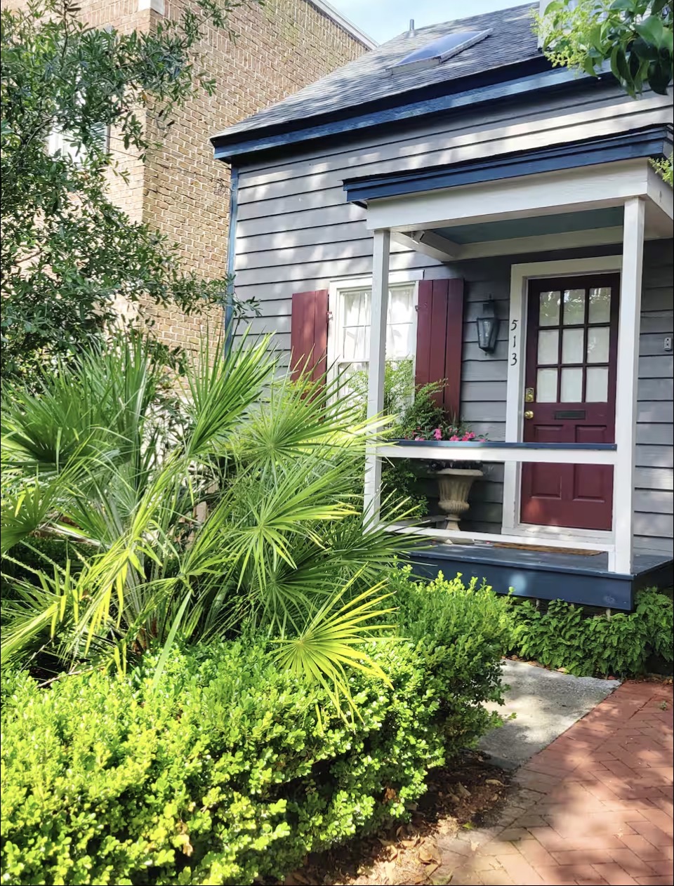 Holly's Cottage exterior with palms